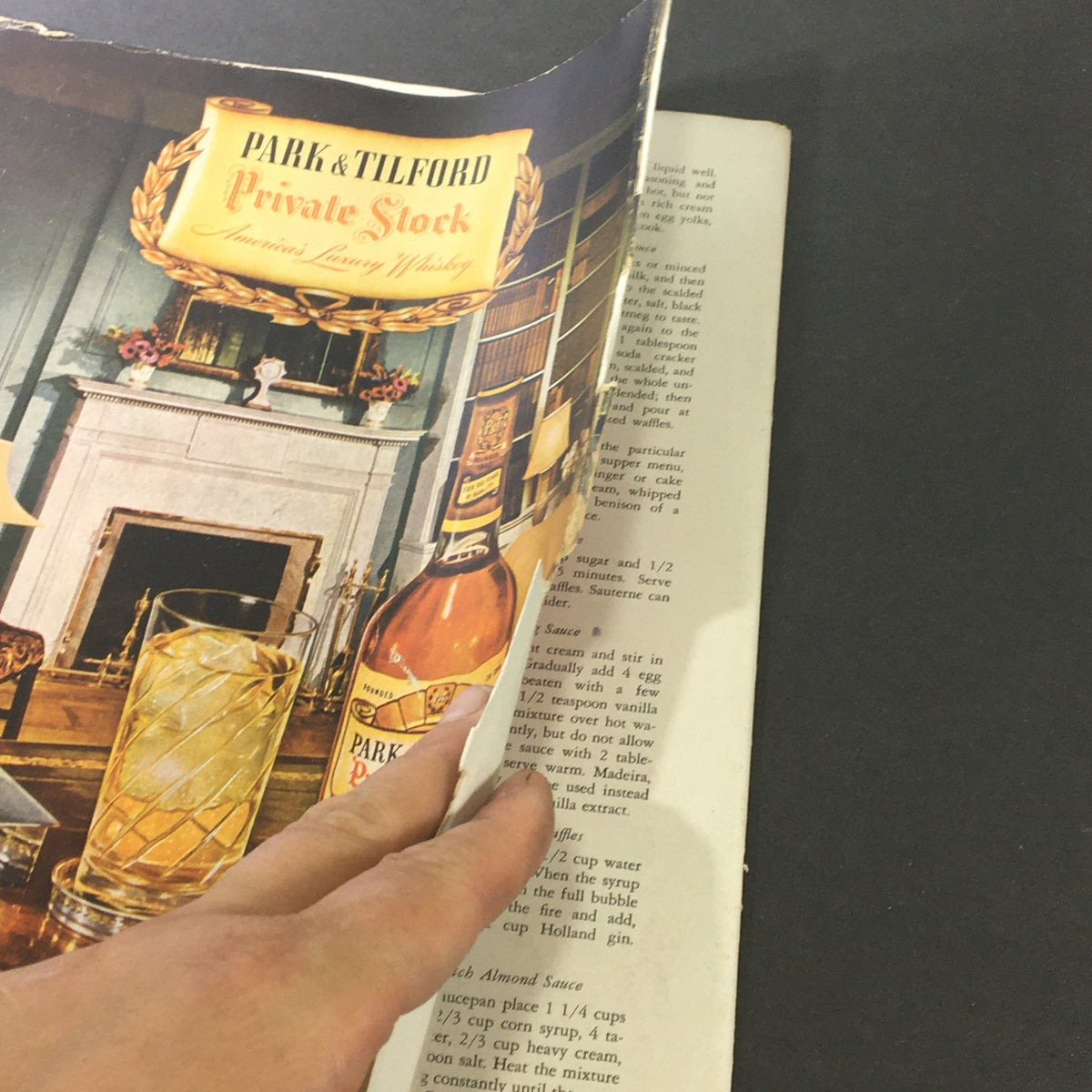 Close-up of the January 1948 VTG Gourmet Magazine featuring a recipe page with a Park & Tilford whiskey advertisement and a glass of whiskey, showcasing vintage culinary content and post-war dining culture.