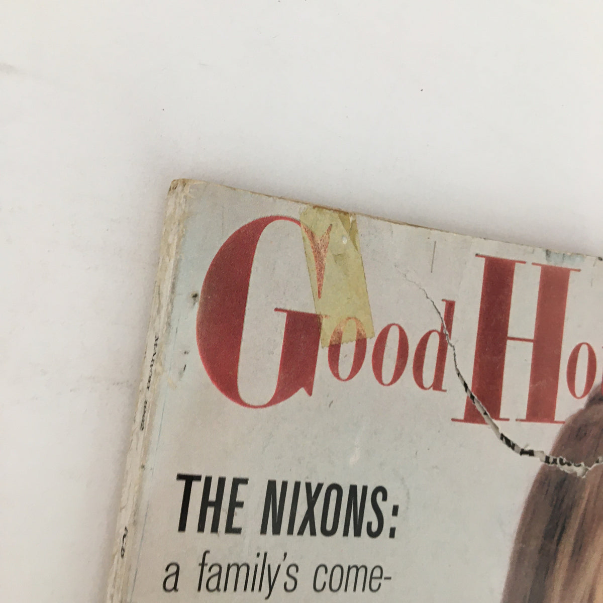 Close-up detail of the cover of Good Housekeeping Magazine March 1962 highlighting the title and the article 'The Nixons: a family's comeback from defeat,' with signs of age and wear.