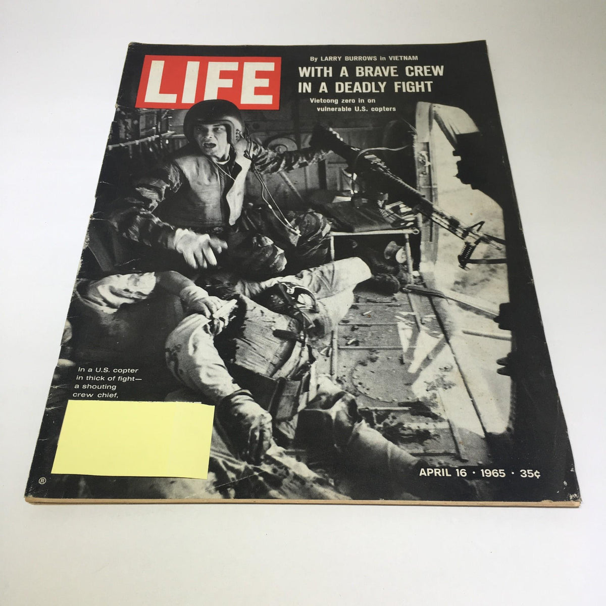 Cover of Life Magazine dated April 16, 1965, featuring the title 'With a Brave Crew in a Deadly Fight.' The image depicts a tense moment inside a U.S. helicopter during combat in Vietnam, highlighting the intense atmosphere of the Vietnam War.