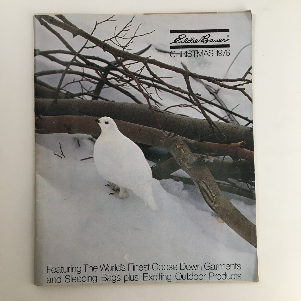 1976 Eddie Bauer Christmas Goose Down Garments Catalog cover featuring a white bird against a snowy background, highlighting winter outdoor products including goose down garments and sleeping bags.