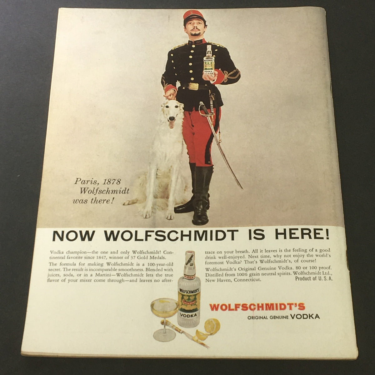 Vintage advertisement from VTG Gourmet Magazine - April 1956, showcasing Wolfschmidt Vodka with a soldier and his dog, promoting its smooth taste and history.