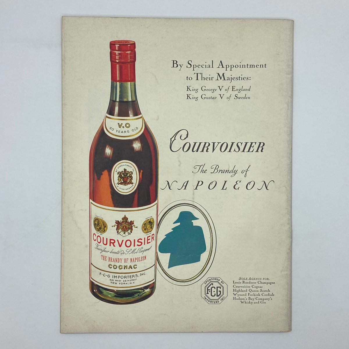Vintage advertisement for Courvoisier cognac showcasing the bottle design with the tagline 'The Brandy of Napoleon'.