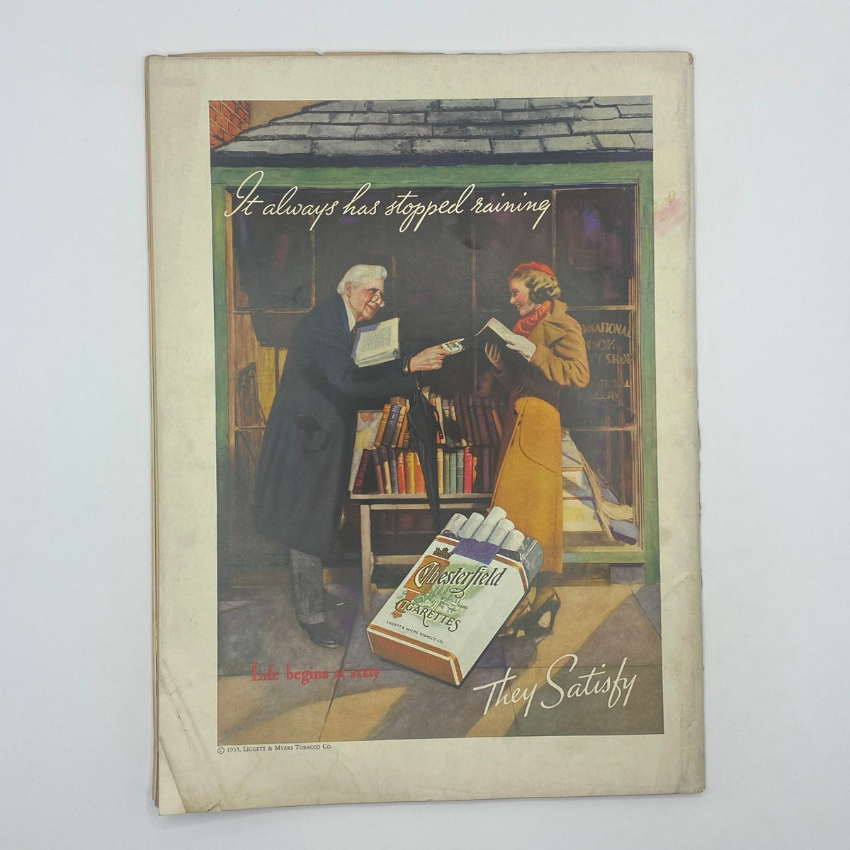 Chesterfield Cigarettes advertisement from The New Yorker April 6, 1935, depicting a man and woman in a bookstore, highlighting the cigarette brand's slogan.