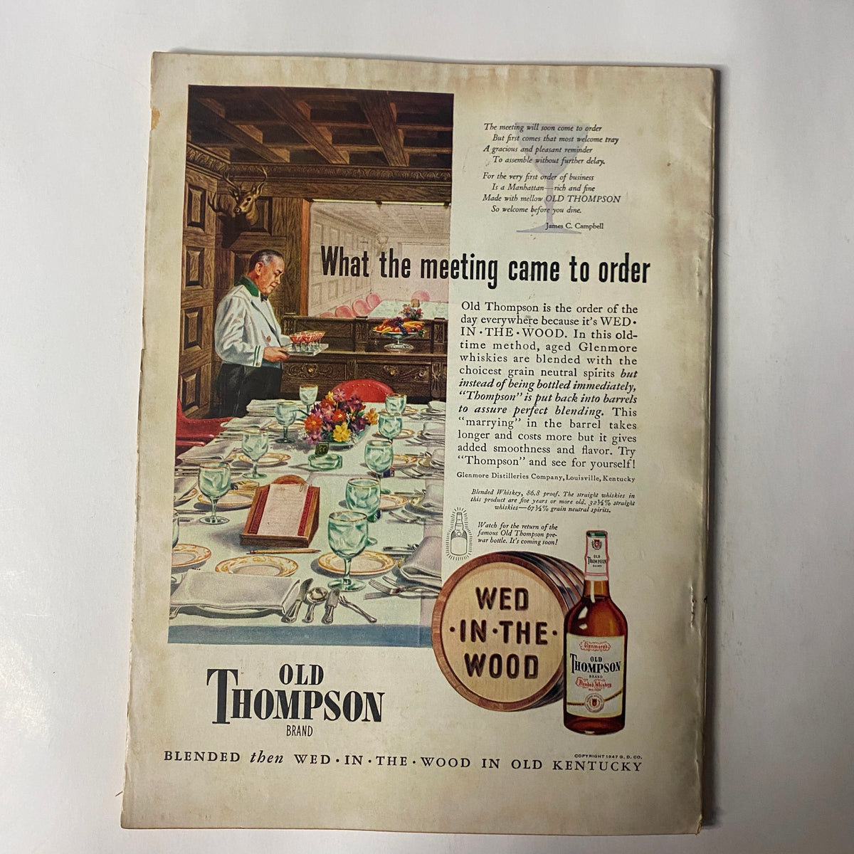 Back cover of Sports Afield Magazine January 1948 featuring an advertisement for Old Thompson brand whiskey, illustrating a dining setup.