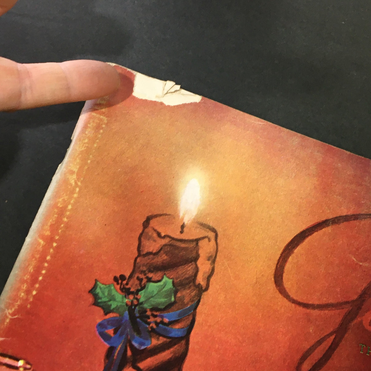 Damaged corner of the cover from December 1951 issue of VTG Gourmet: The Magazine of Good Living, featuring a candle illustration and holiday decorations.