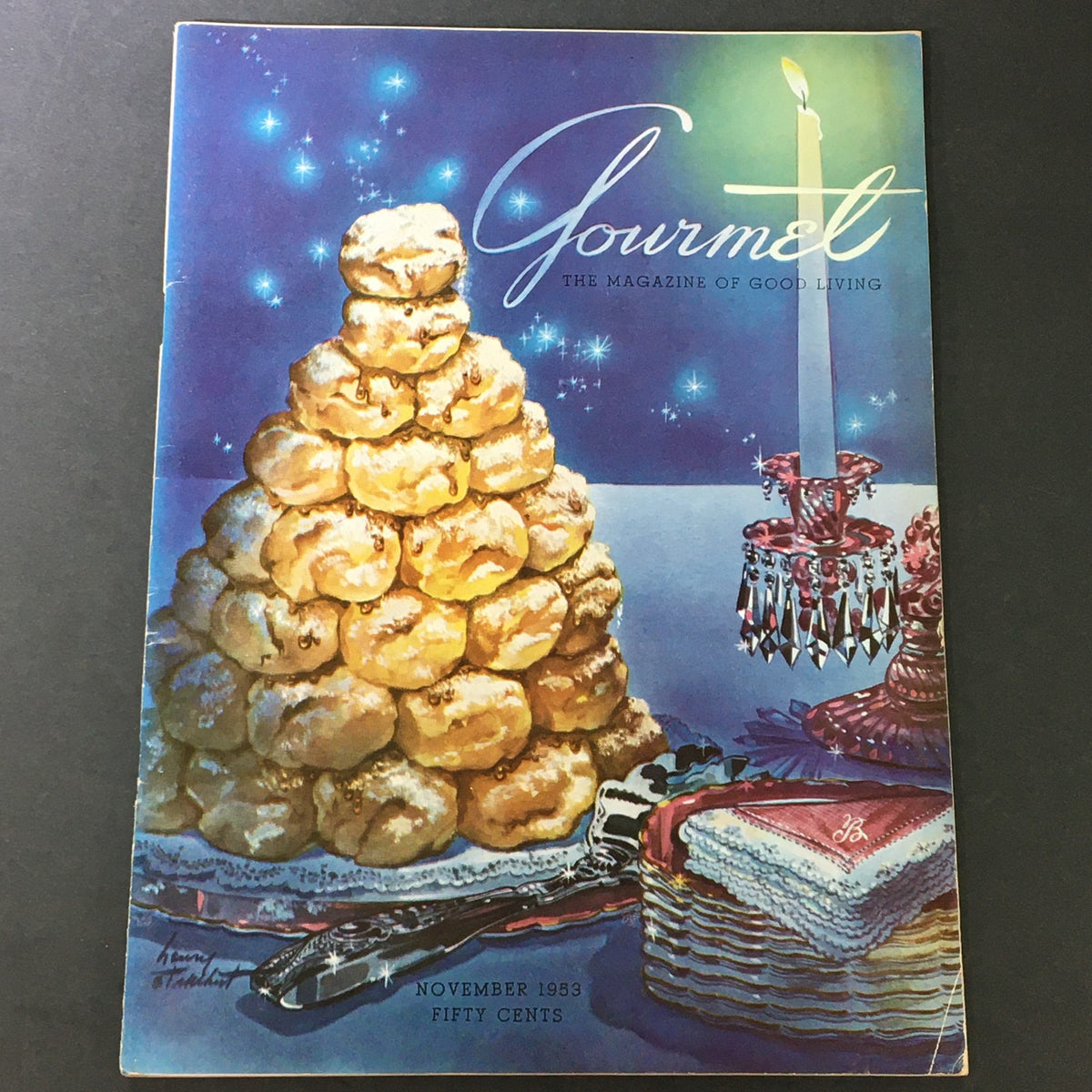 Cover of VTG Gourmet The Magazine of Good Living November 1953 featuring a festive dessert display with a tower of cream puffs and a candle, capturing mid-20th century elegance.