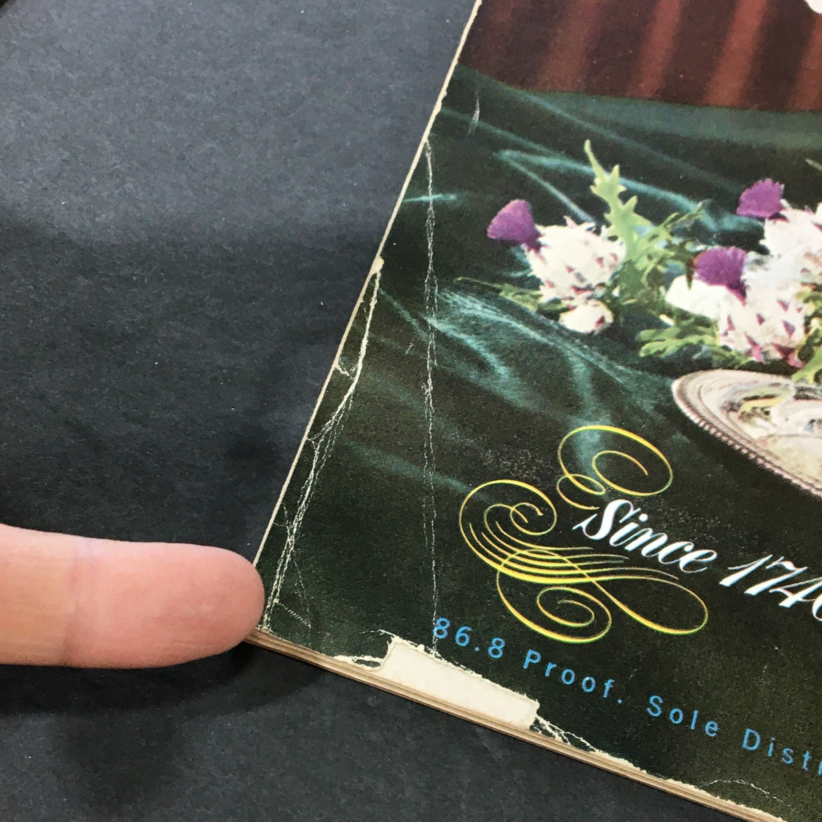 Close-up of the back cover of VTG Gourmet The Magazine of Good Living November 1953, detailing a well-worn edge with decorative elements, reflecting the magazine's vintage charm.