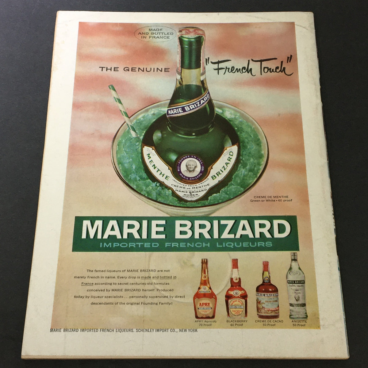 Back cover of VTG Gourmet The Magazine of Good Living June 1957, showcasing an advertisement for Marie Brizard, highlighting imported French liqueurs in a vintage style.