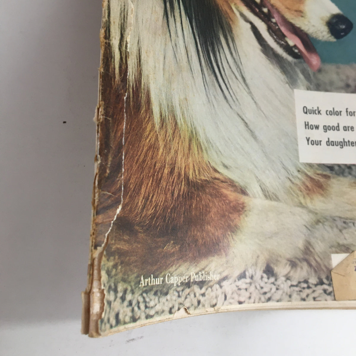 Side view highlighting wear on the spine of Household Magazine January 1952, showcasing its vintage condition.