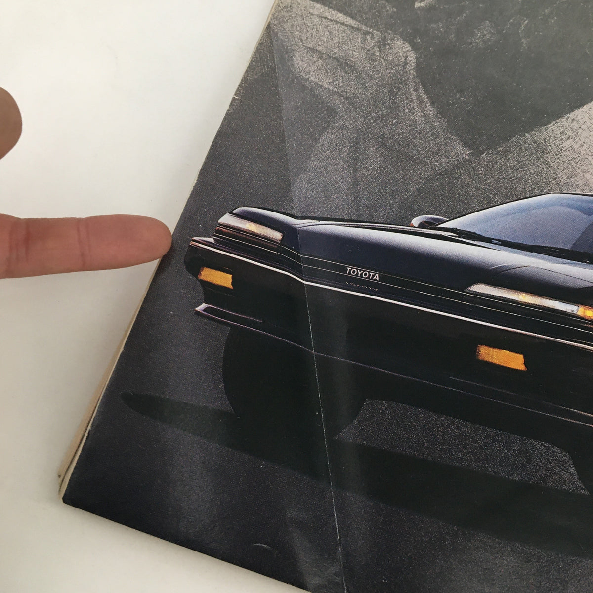 Close-up shot of a Toyota Corolla advertisement page from Rolling Stone Magazine November 17 1988, with focus on the car's branding and design details.