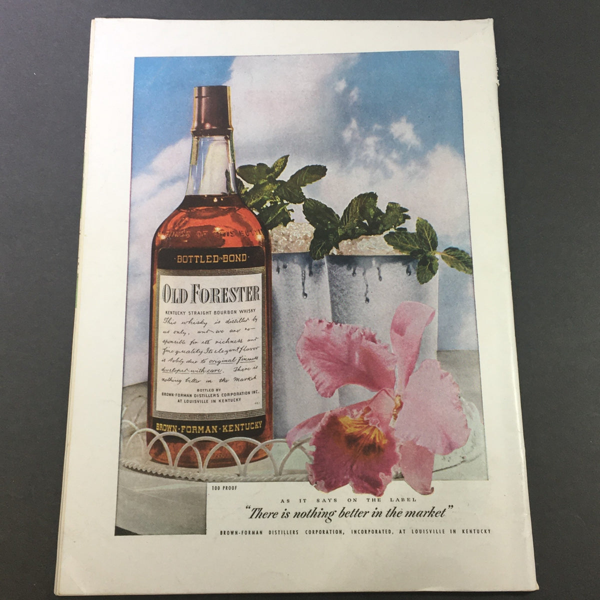 Back cover of VTG Gourmet The Magazine of Good Living July 1947 showcasing an Old Forester bourbon bottle accompanied by decorative plants.