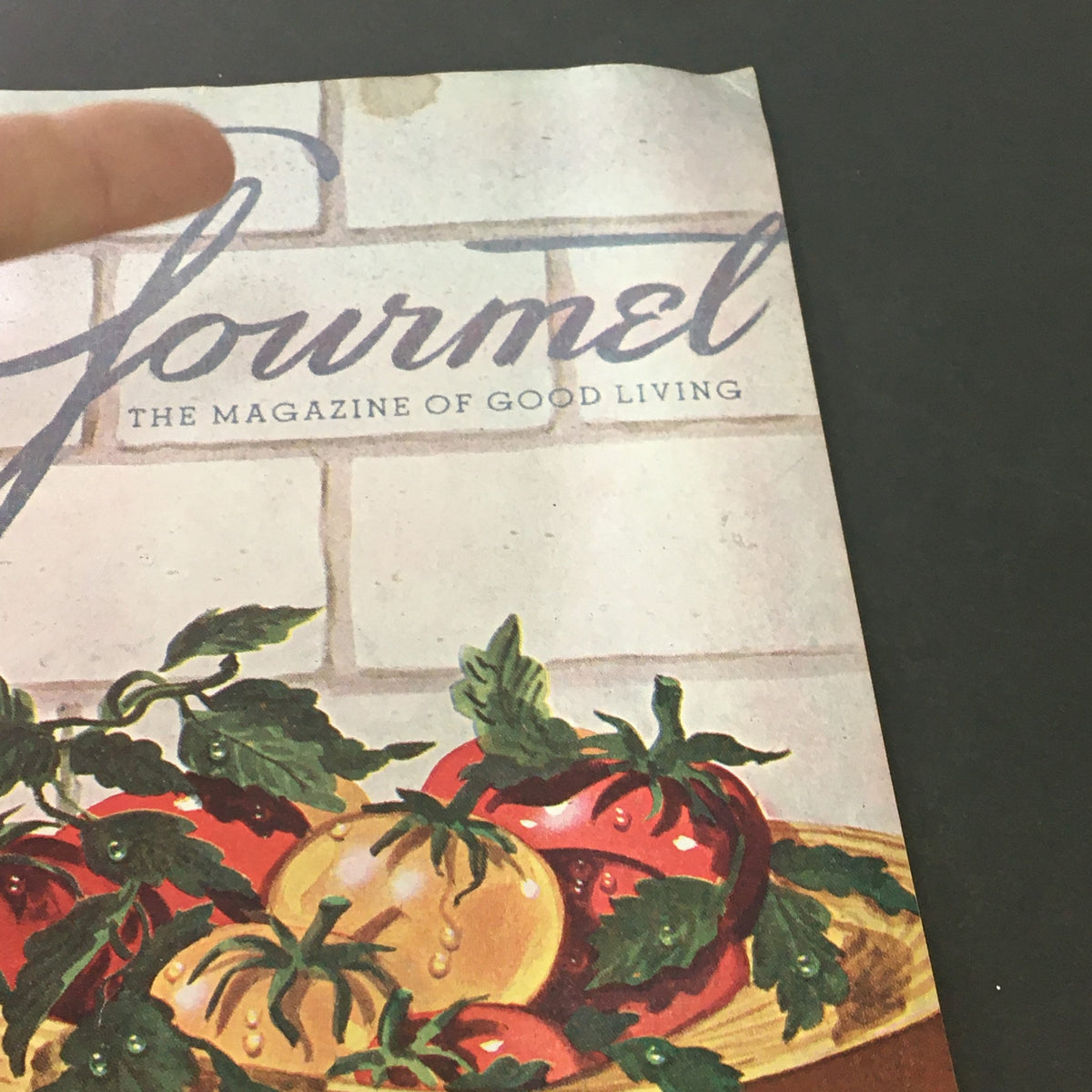 Close-up view of the cover of VTG Gourmet The Magazine of Good Living September 1949, showcasing vibrant tomatoes and the magazine's title in vintage typography.