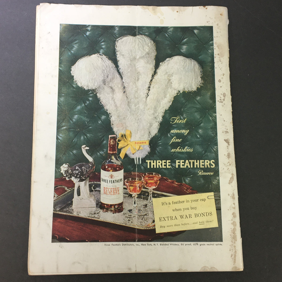 Advertisement from September 1944 issue of VTG Gourmet The Magazine of Good Living promoting Three Feathers Reserve whiskey.