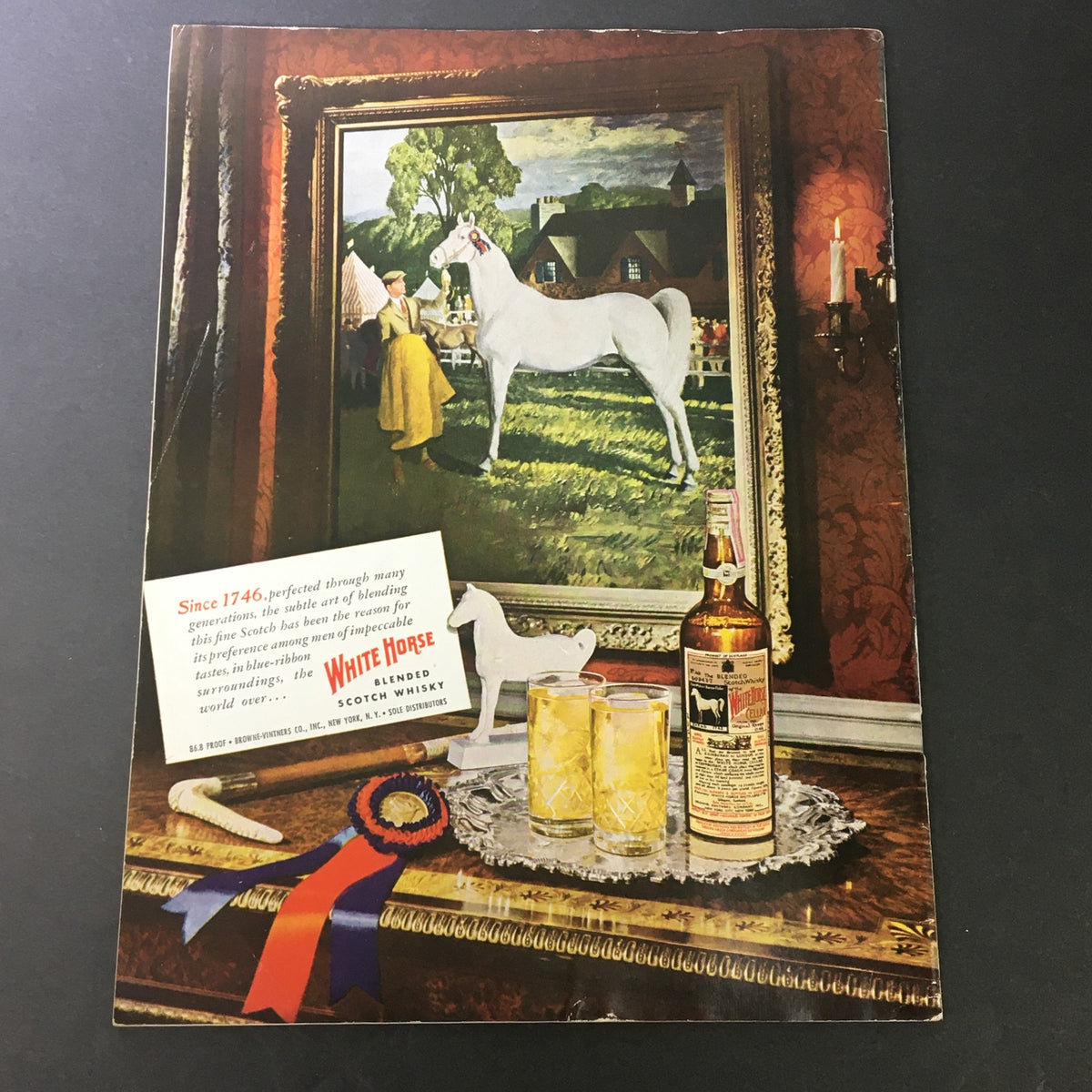 Back cover of VTG Gourmet The Magazine of Good Living May 1949 showcasing an advertisement for White Horse Blended Scotch Whisky with a decorative setting.