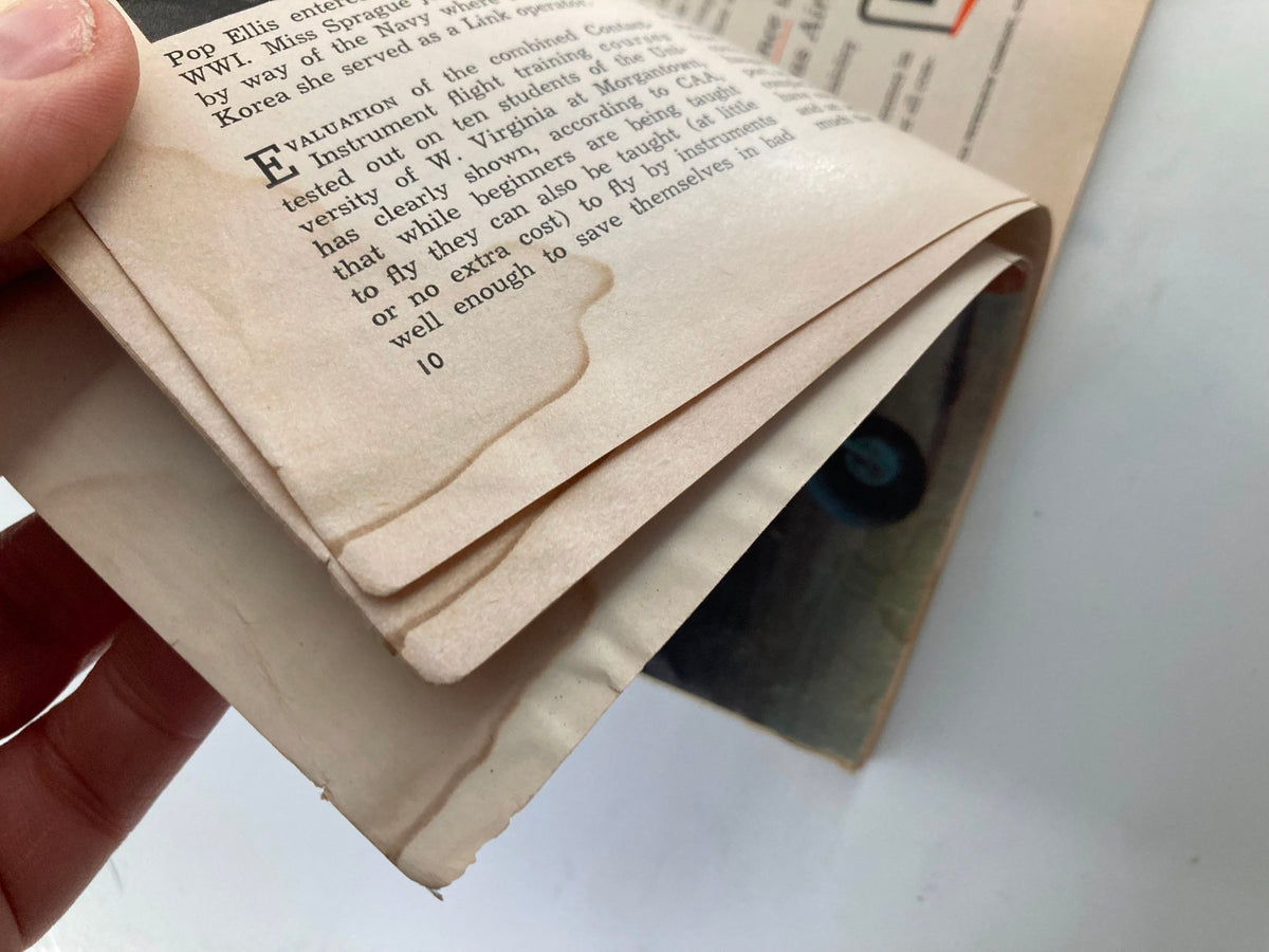 Interior page of VTG Flying Magazine April 1958 showing yellowed, worn pages with slight water marks, indicating its vintage condition.
