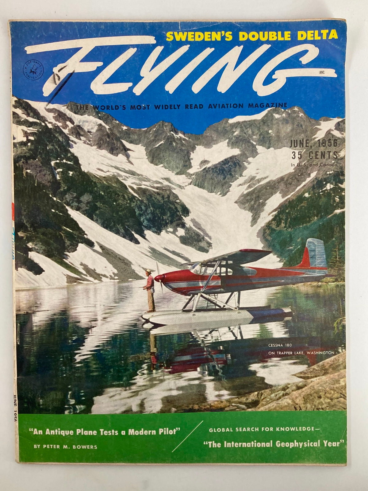 Cover of VTG Flying Magazine June 1956 featuring the Cessna 180 on Trapper Lake, Washington, showcasing a scenic landscape with mountains and a seaplane.