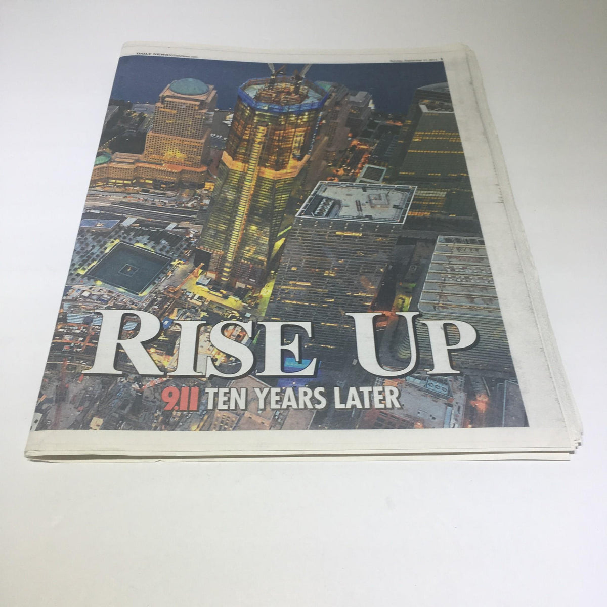 Side view of the New York Daily News magazine titled 'Rise Up 911 Ten Years Later', highlighting its collectible status and historical significance.