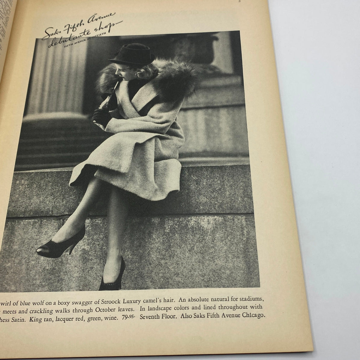 A stylish black-and-white fashion advertisement from The New Yorker, October 16, 1937, featuring a woman wearing a luxurious coat, promoting Saks Fifth Avenue. A unique piece of vintage fashion history.