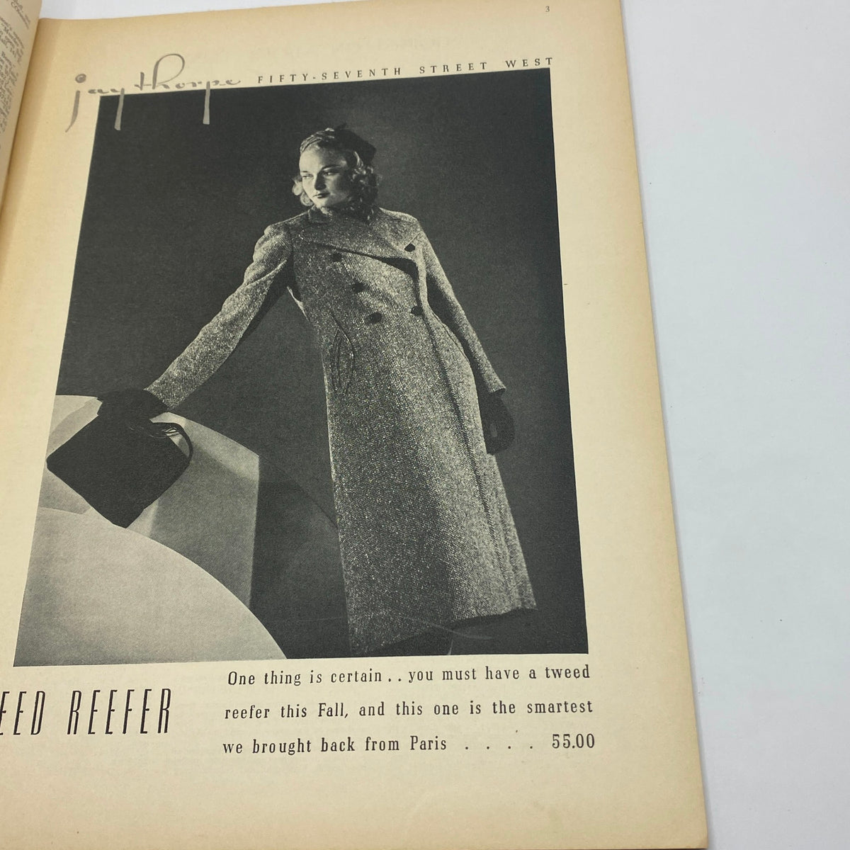Page in The New Yorker magazine showcasing a fashion advertisement for a tweed reefer coat, highlighting style trends of October 1937.