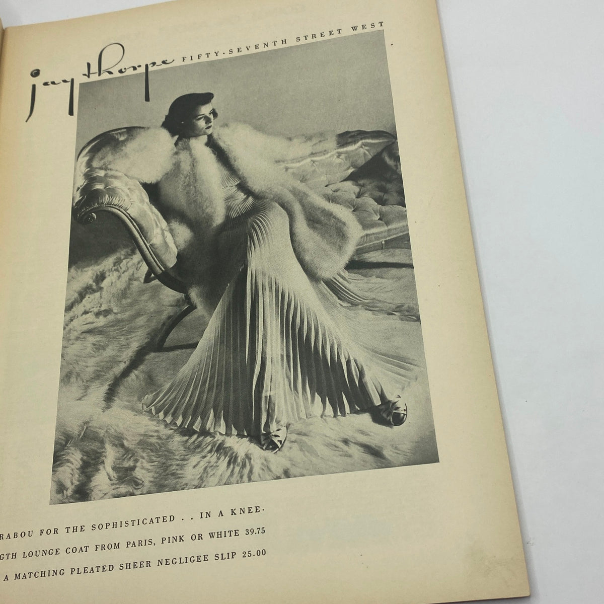 Fashion advertisement from The New Yorker Complete Magazine November 7, 1936, showcasing a model in a luxurious outfit with a fur coat.