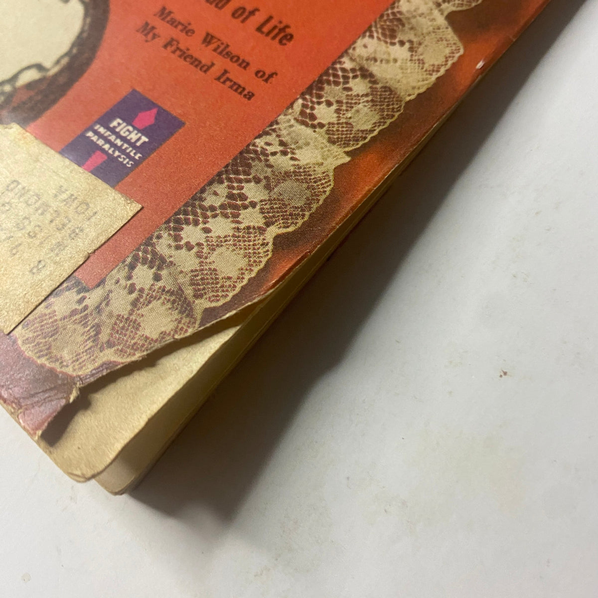Close-up view of the side edge of the February 1950 issue of Radio and TV Mirror Magazine, highlighting wear and tear, along with the visible page margin for collectors.
