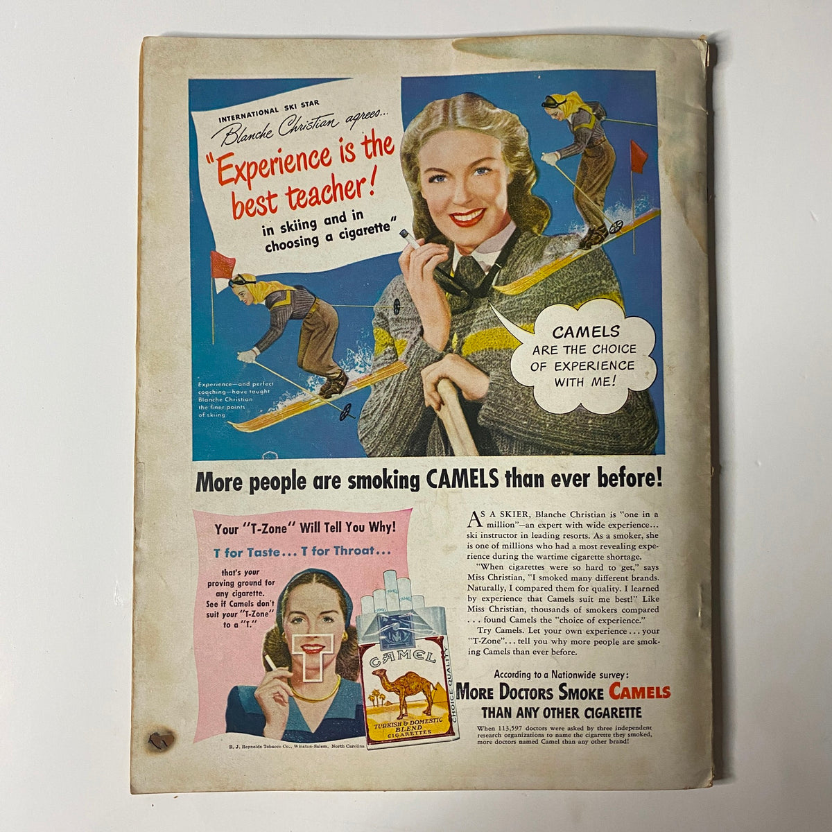 Advertisement on the back cover of True: The Man's Magazine February 1948 featuring a woman skiing with a Camel cigarette promotion.