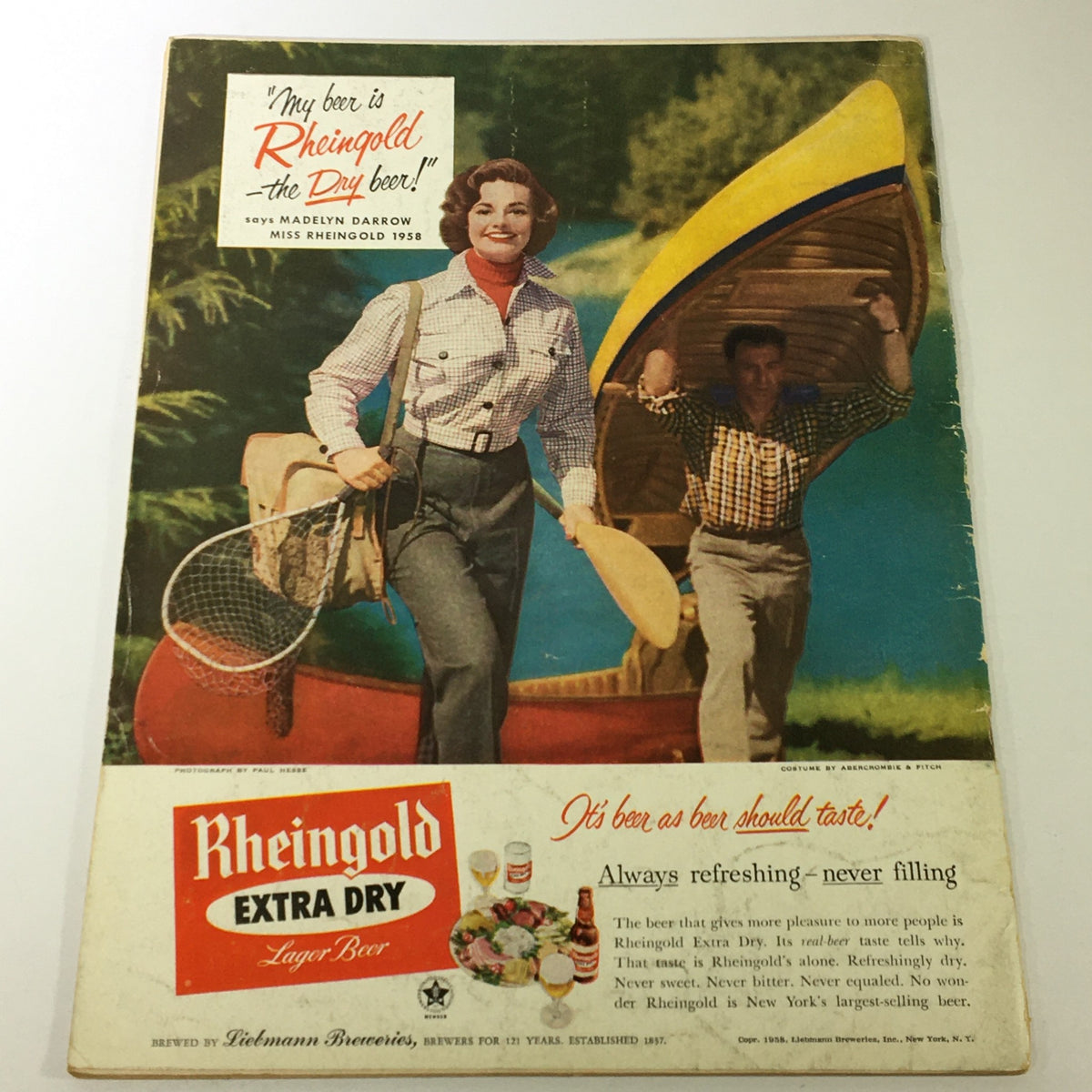 Cover of VTG Gourmet The Magazine of Good Living July 1958 featuring a vintage advertisement for Rheingold Extra Dry Lager Beer with two models enjoying outdoor activities by a lake.