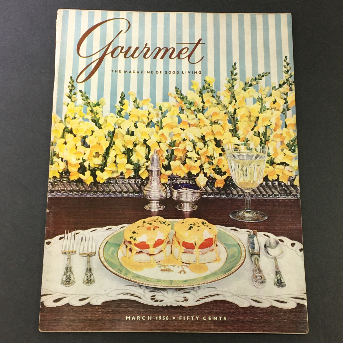 Cover of VTG Gourmet The Magazine of Good Living March 1958 issue titled 'The Egg Came First', featuring a beautifully set table with dishes and vibrant yellow flowers.