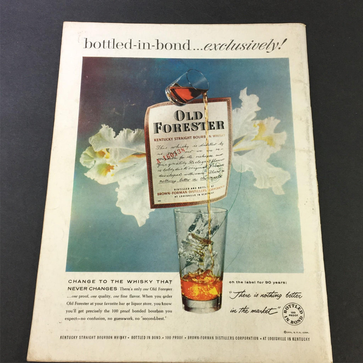 VTG Gourmet The Magazine of Good Living April 1959 vintage advertisement for Old Forester bourbon showcasing a bottle and glass with flowing liquor against an artistic background.
