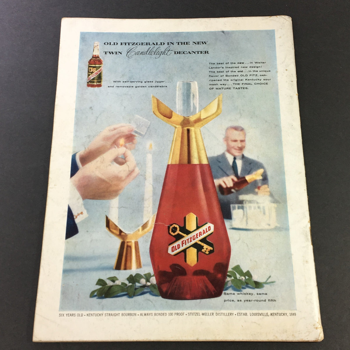 Advertisement for Old Fitzgerald Bourbon featuring the new Candlelight Decanter, showcasing a sophisticated setting with a man serving whiskey, from the October 1956 issue of VTG Gourmet The Magazine of Good Living.
