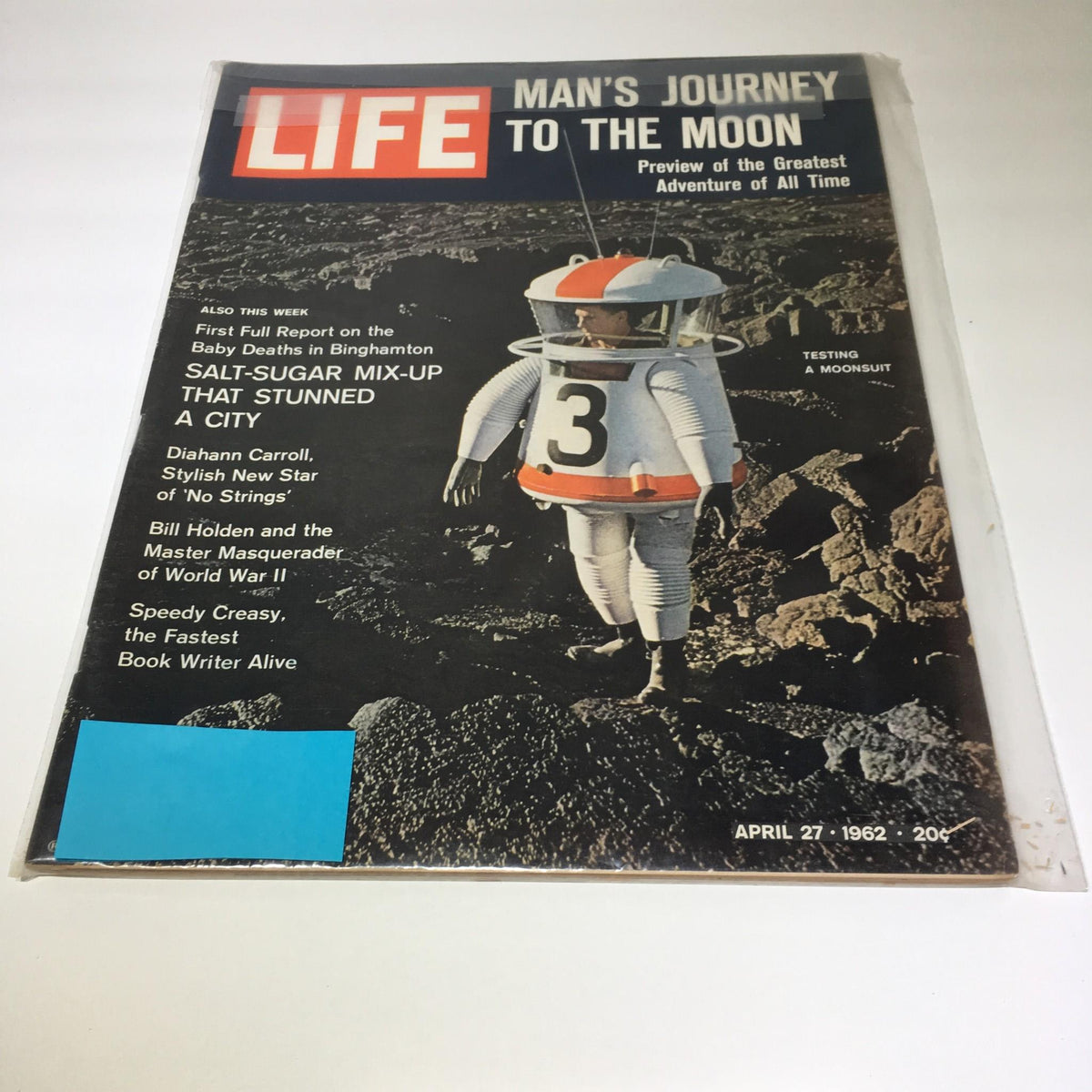 Life Magazine cover from April 27, 1962 showcasing 'Man's Journey to the Moon' with a featured image of an astronaut testing a moonsuit against a lunar landscape.