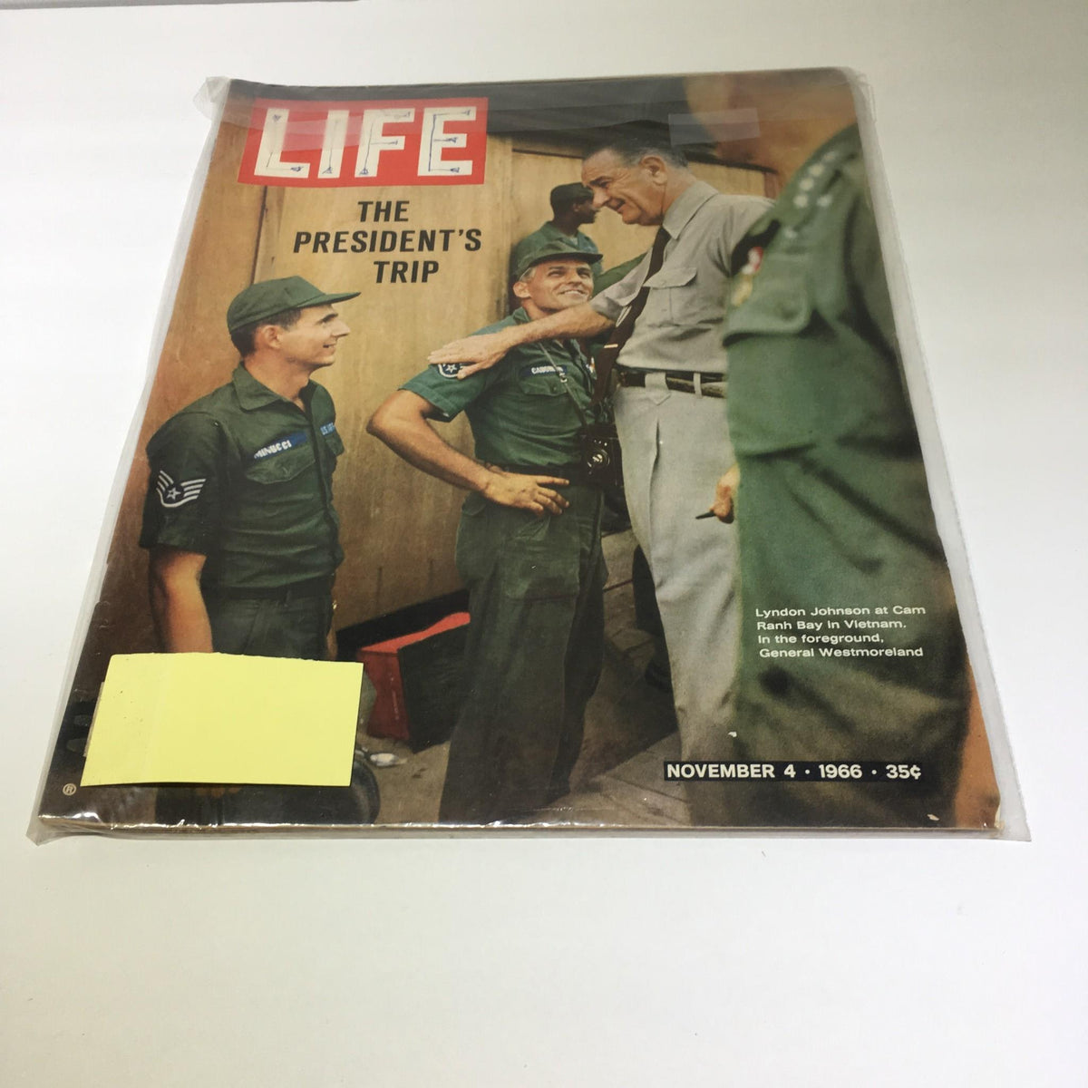 Vintage Life Magazine cover from November 4, 1966, featuring President Lyndon Johnson at Cam Ranh Bay, Vietnam, surrounded by military personnel, showcasing a significant moment during the Vietnam War.