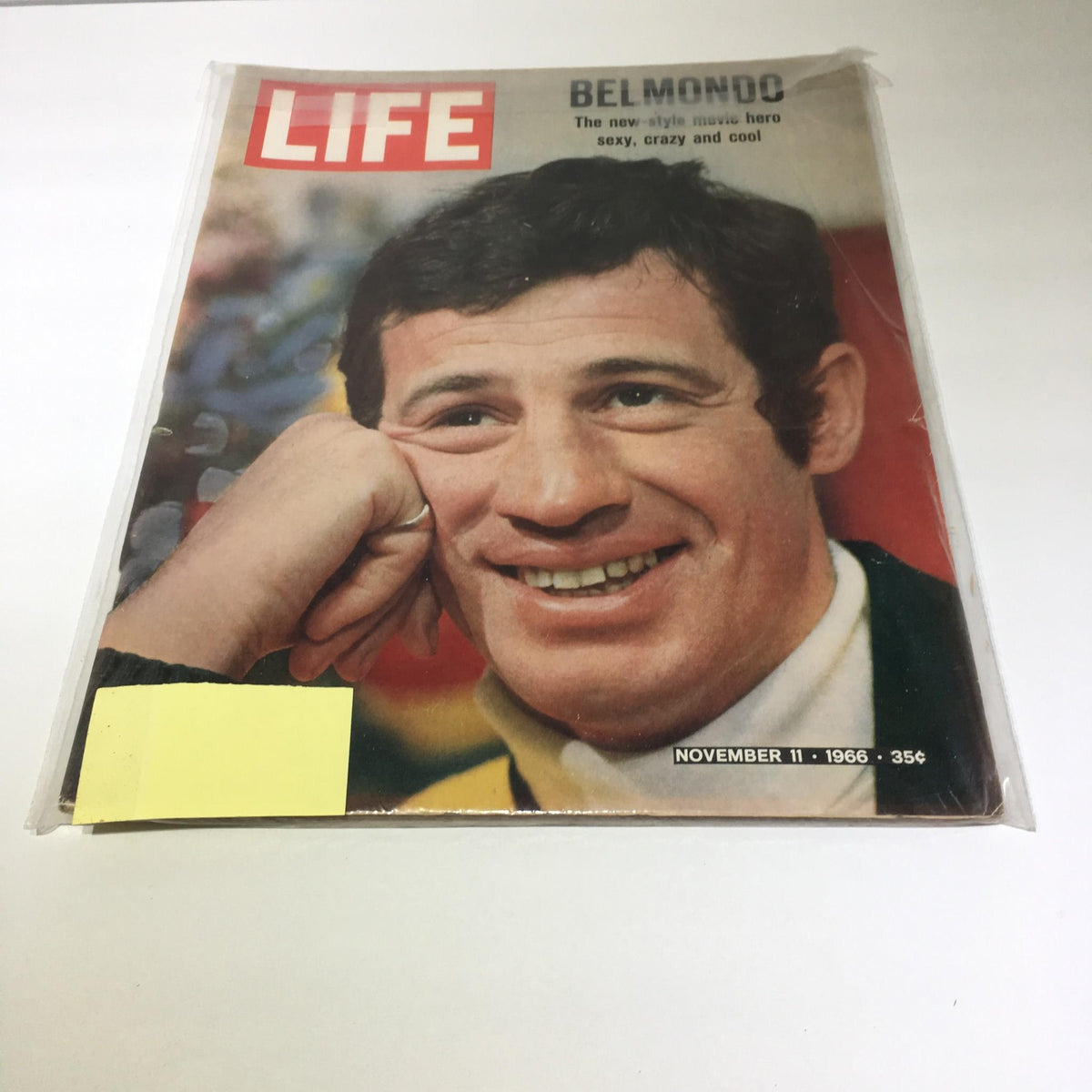 Cover of Life Magazine from November 11, 1966, featuring Jean Paul Belmondo, known as the new-style movie hero, with a vibrant expression. The magazine highlights Belmondo's impact on cinema and is a collectible item for vintage magazine enthusiasts.