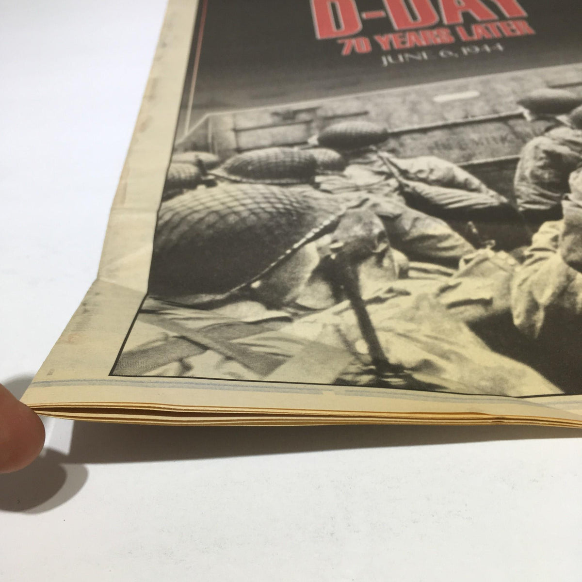 Detailed view of the New York Daily News D-Day 70 Years Later publication's edge, showcasing wear and historical significance, June 6, 1944.