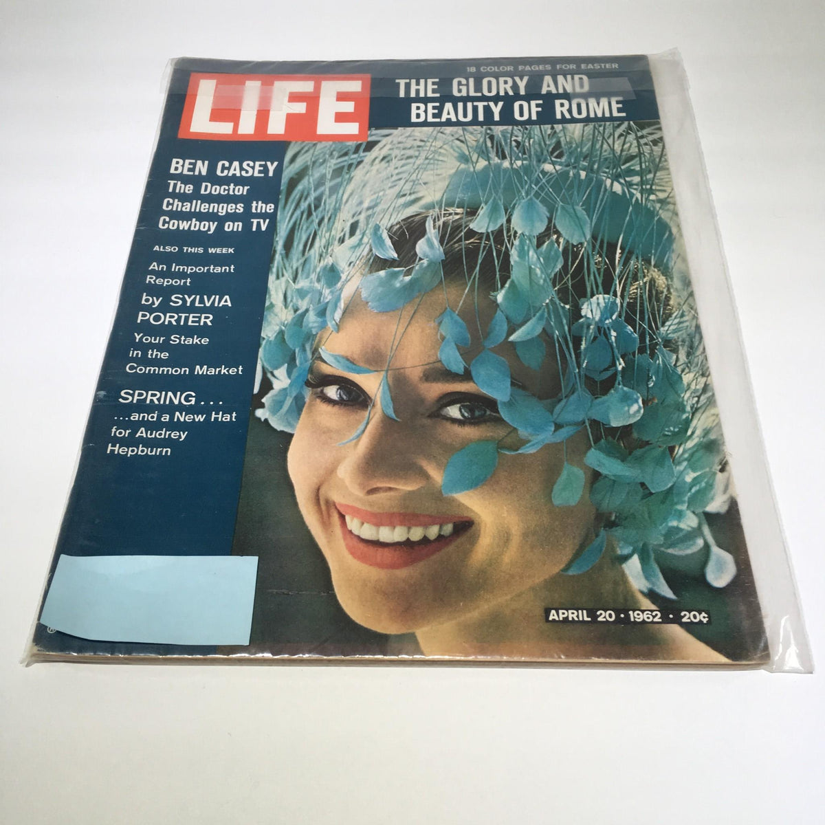 Life Magazine: April 20, 1962, cover featuring 'The Glory and Beauty of Rome' with a vibrant photograph of a smiling woman adorned with blue flowers, highlighting the charm and elegance of the era.