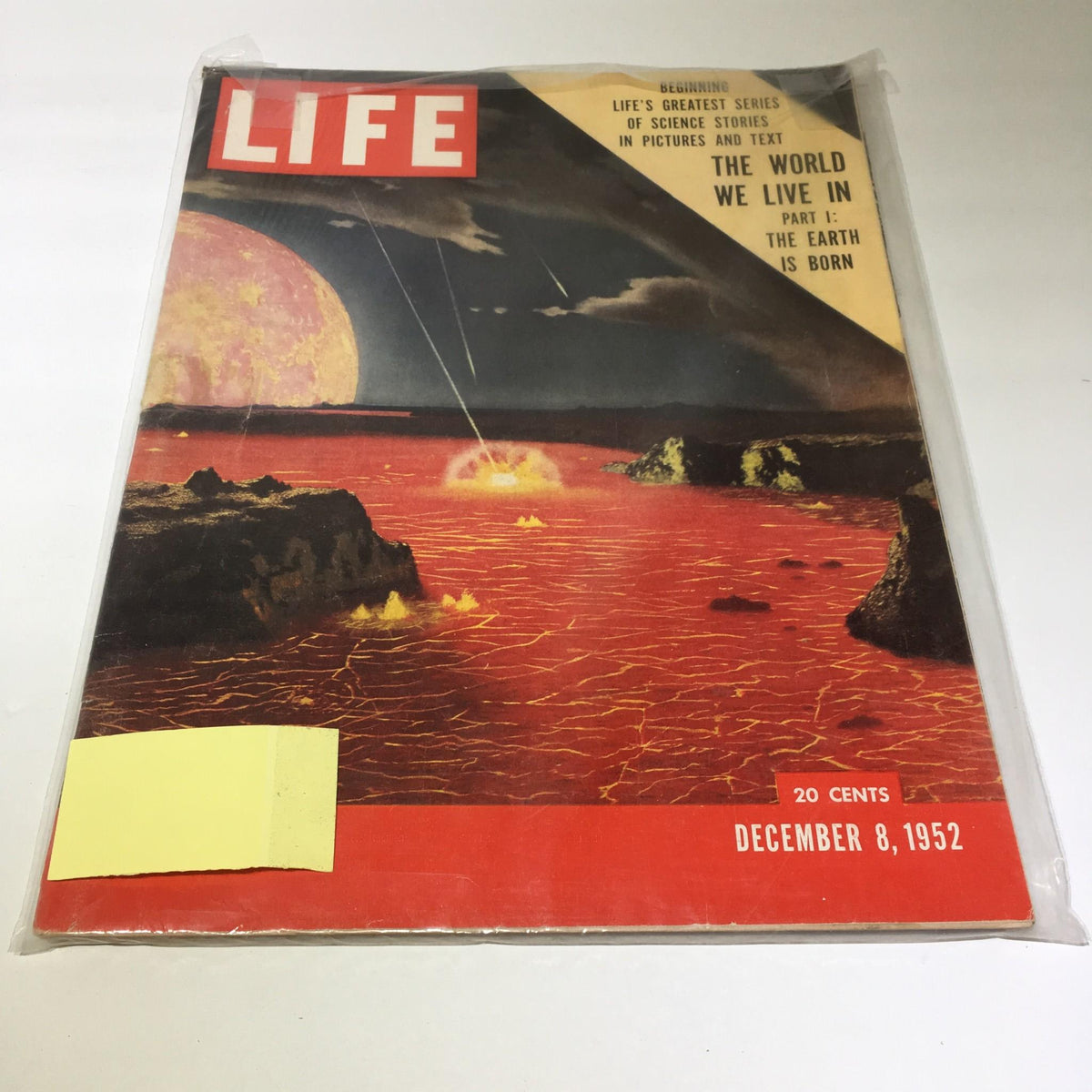Cover of Life Magazine, December 8, 1952, titled 'The World We Live in Part I: Earth is Born', showcasing a visually striking depiction of Earth's early formation with volcanic landscapes and fiery elements, preserved in protective plastic.