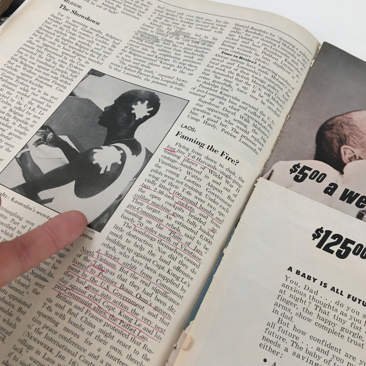 Detailed view of interior pages from Newsweek Magazine January 23 1961 featuring highlighted text regarding Laos and an advertising page about family insurance.