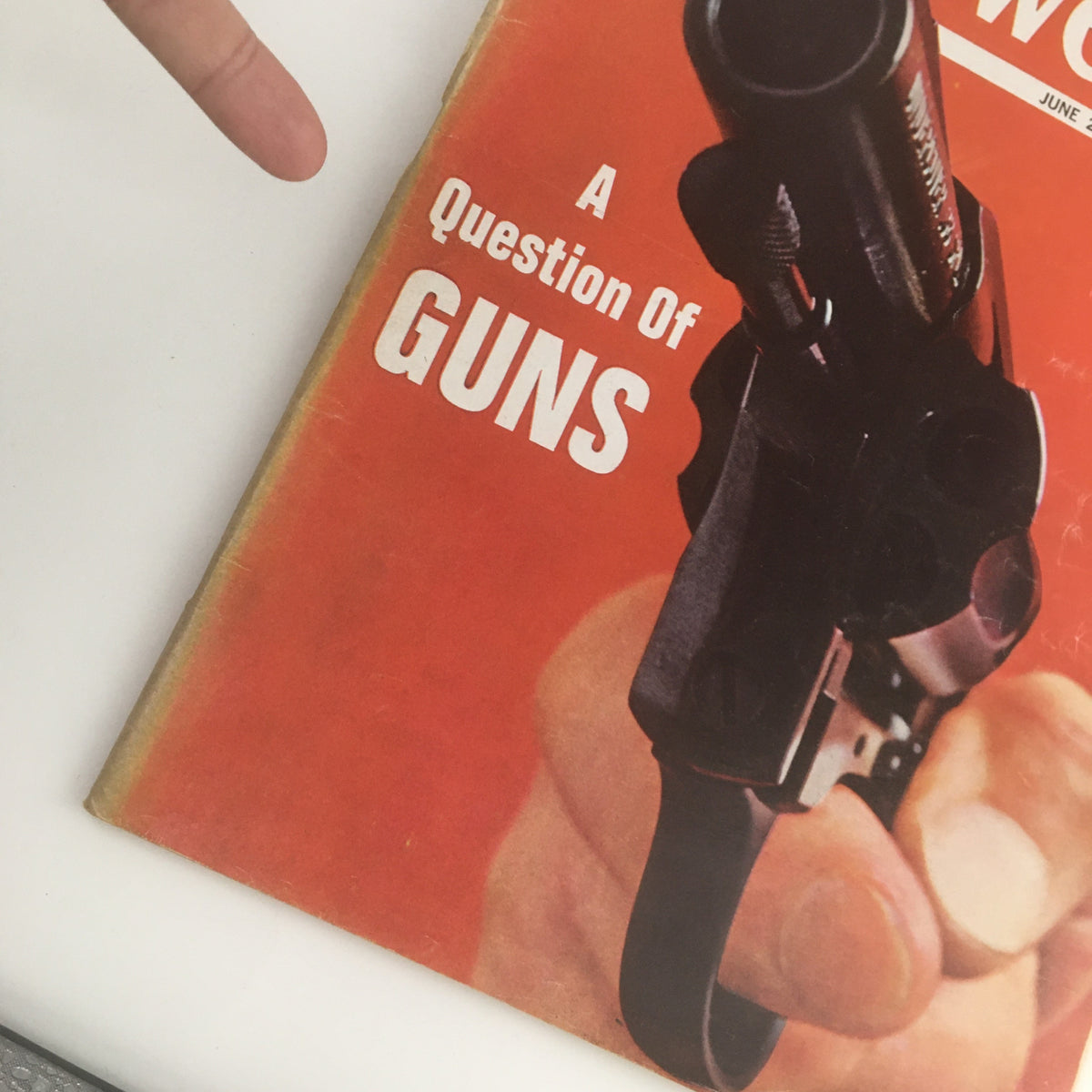 Close-up view of the cover of Newsweek Magazine June 24, 1968 highlighting the title 'A Question About The Guns' alongside the image of a revolver held by a hand.