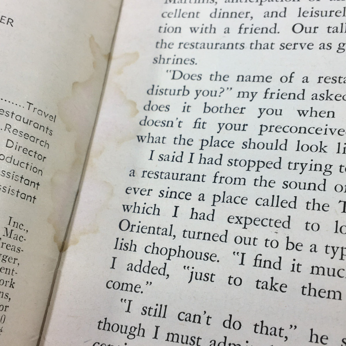 Interior page of VTG Gourmet Magazine February 1959, detailing an article about dining experiences with visible text and some water stains, reflecting vintage culinary culture.