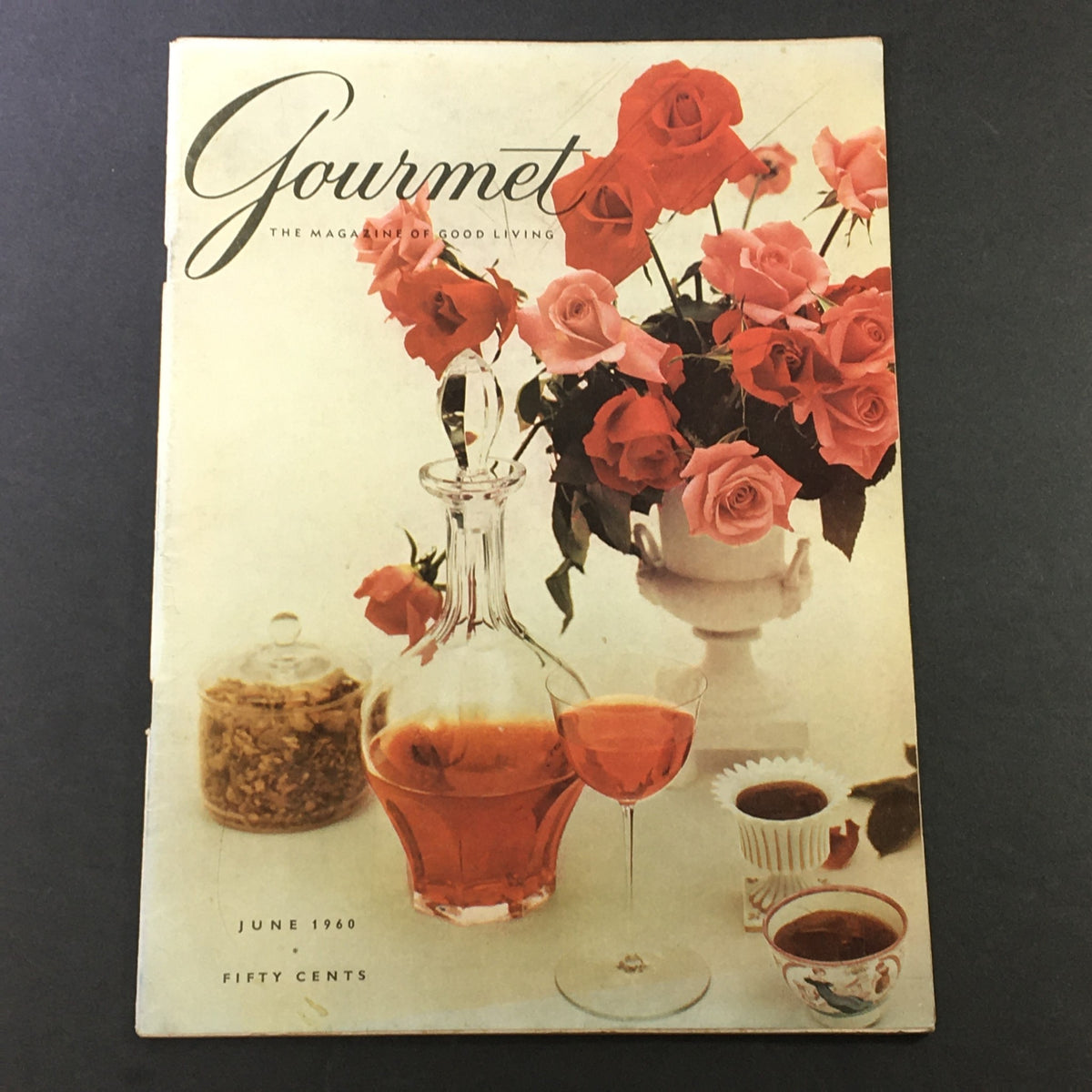 Cover of VTG Gourmet The Magazine of Good Living June 1960 featuring a decorative presentation of roses and a glass of drink, encapsulating the essence of vintage culinary culture.