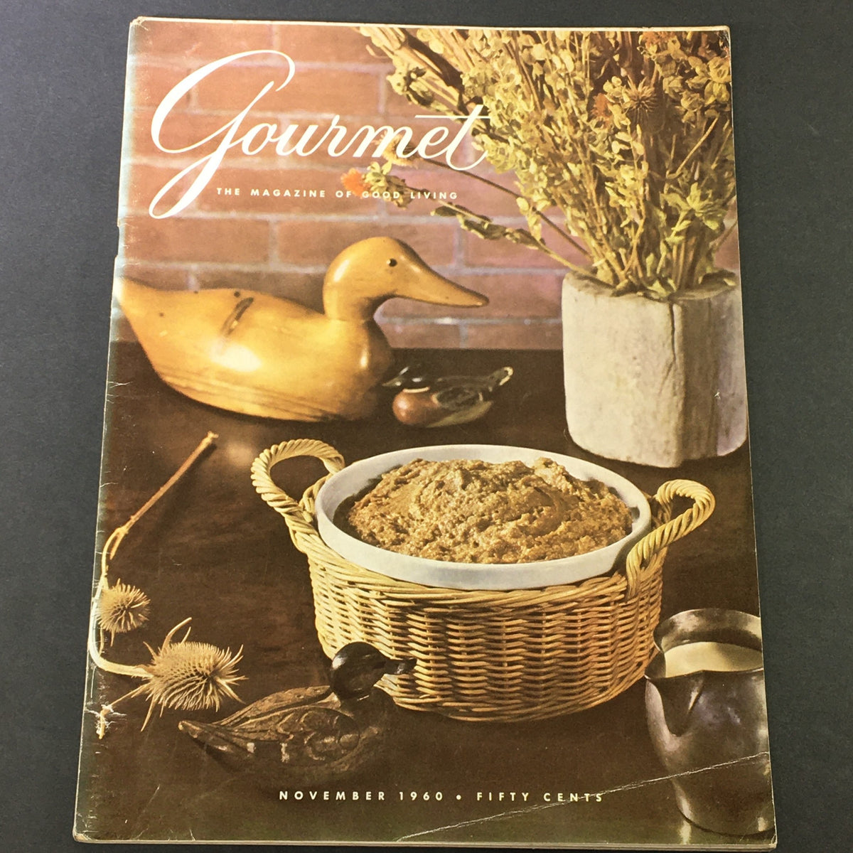Cover of VTG Gourmet Magazine, November 1960, featuring a wooden duck figurine, a flower vase, and a basket of food, showcasing Chilean kitchen memories.