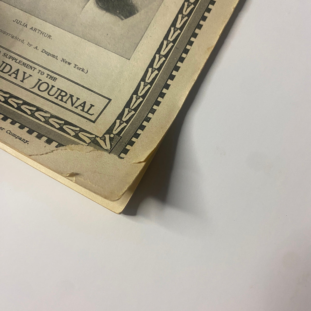 Close-up view of the bottom corner of The New England Home Magazine from May 14, 1899, showing wear and tear typical for its age.