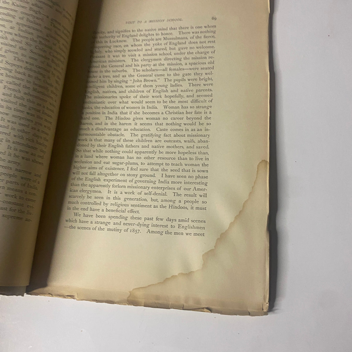Page view from 'Around the World with General Grant' Book by John Russell Young, featuring text with a torn corner and historical context.