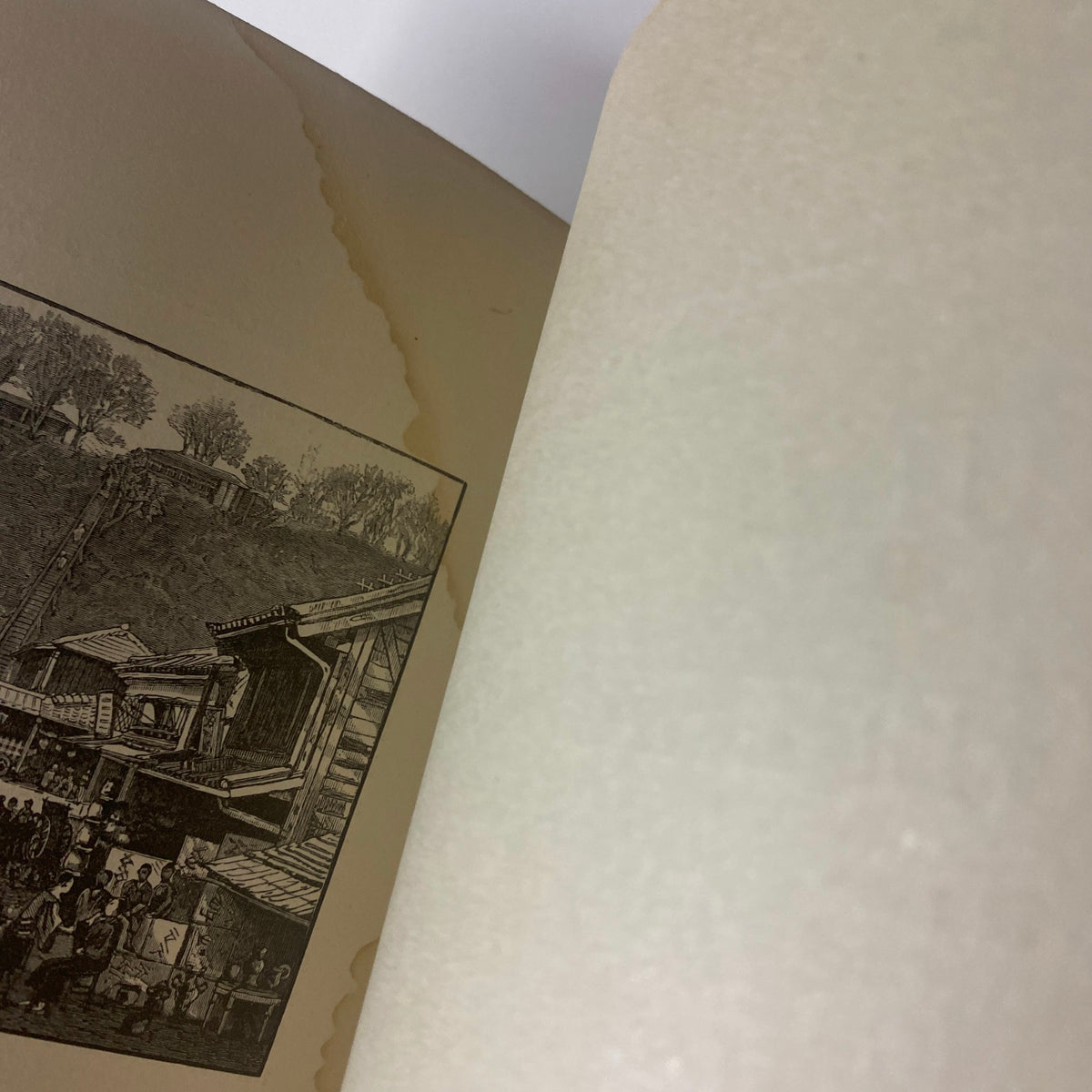 Another view of the interior of 'Around the World with General Grant' by John Russell Young, Part Nineteen, highlighting a page with an illustration and wear.