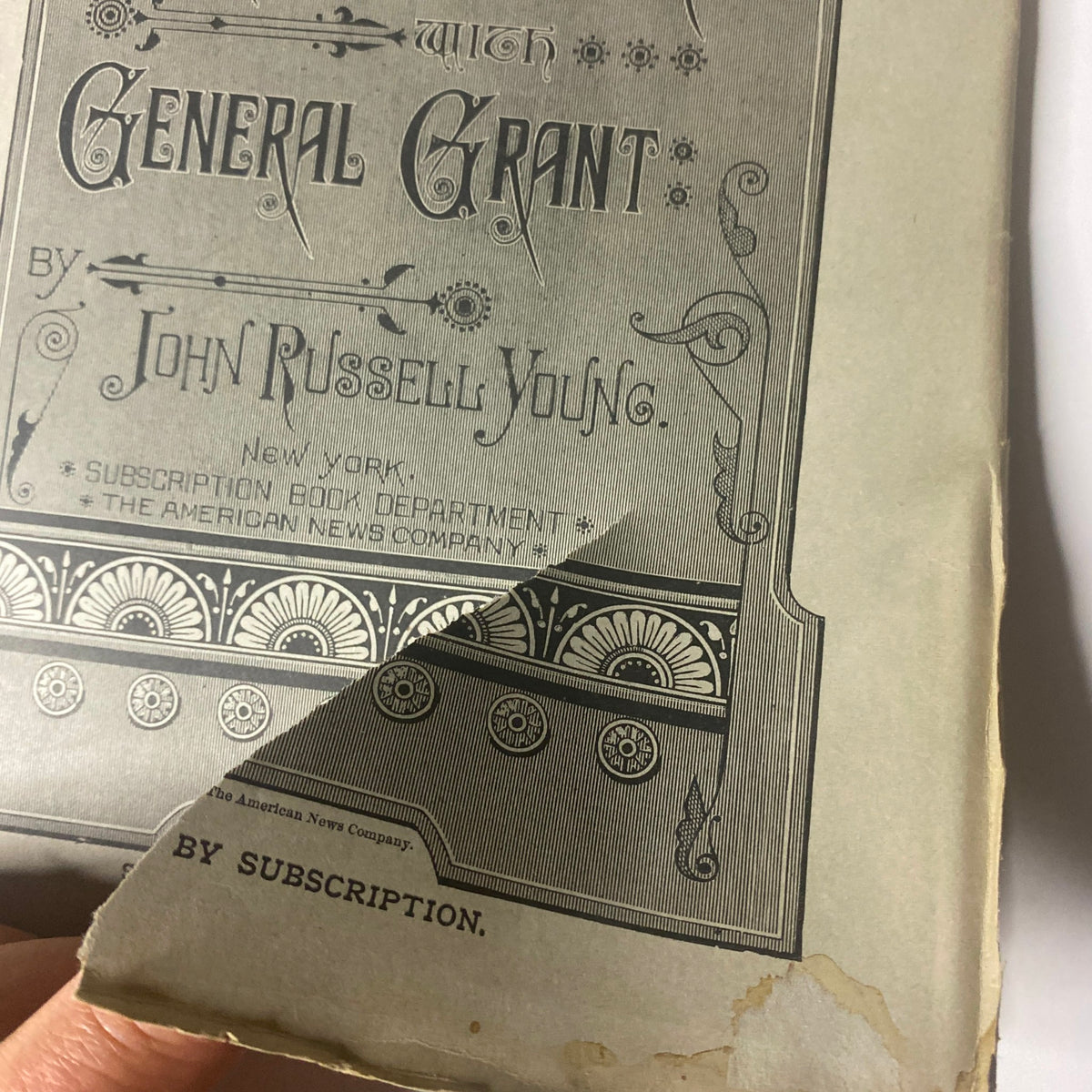 Close-up view of the cover page of 'Around the World with General Grant' by John Russell Young, highlighting the title and author's name.