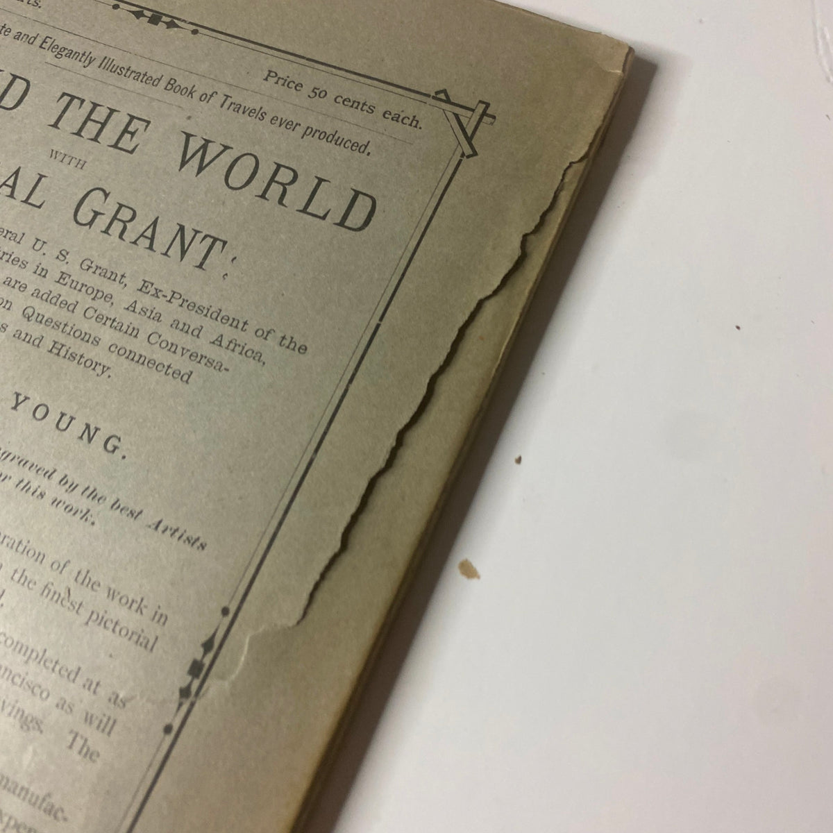 Close-up of the cover of 'Around the World with General Grant' Book by John Russell Young, highlighting damage along the edge, illustrating wear consistent with age.