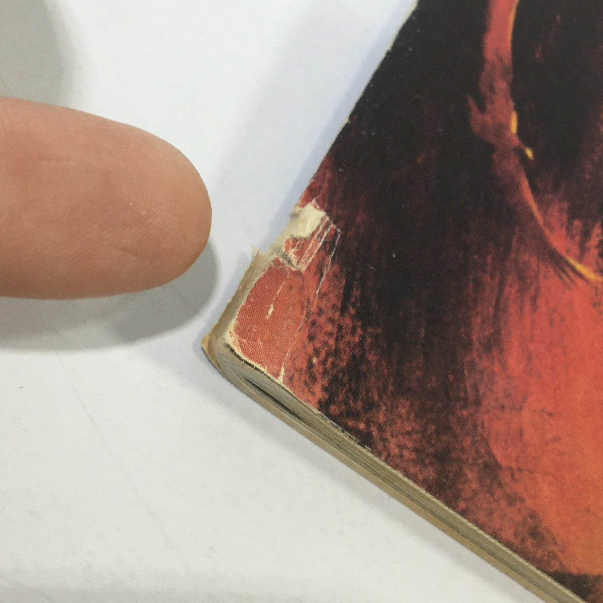 Close-up view of the edge of Cinefantastique magazine showing minor wear and tear, highlighting some imperfections and a small rip.