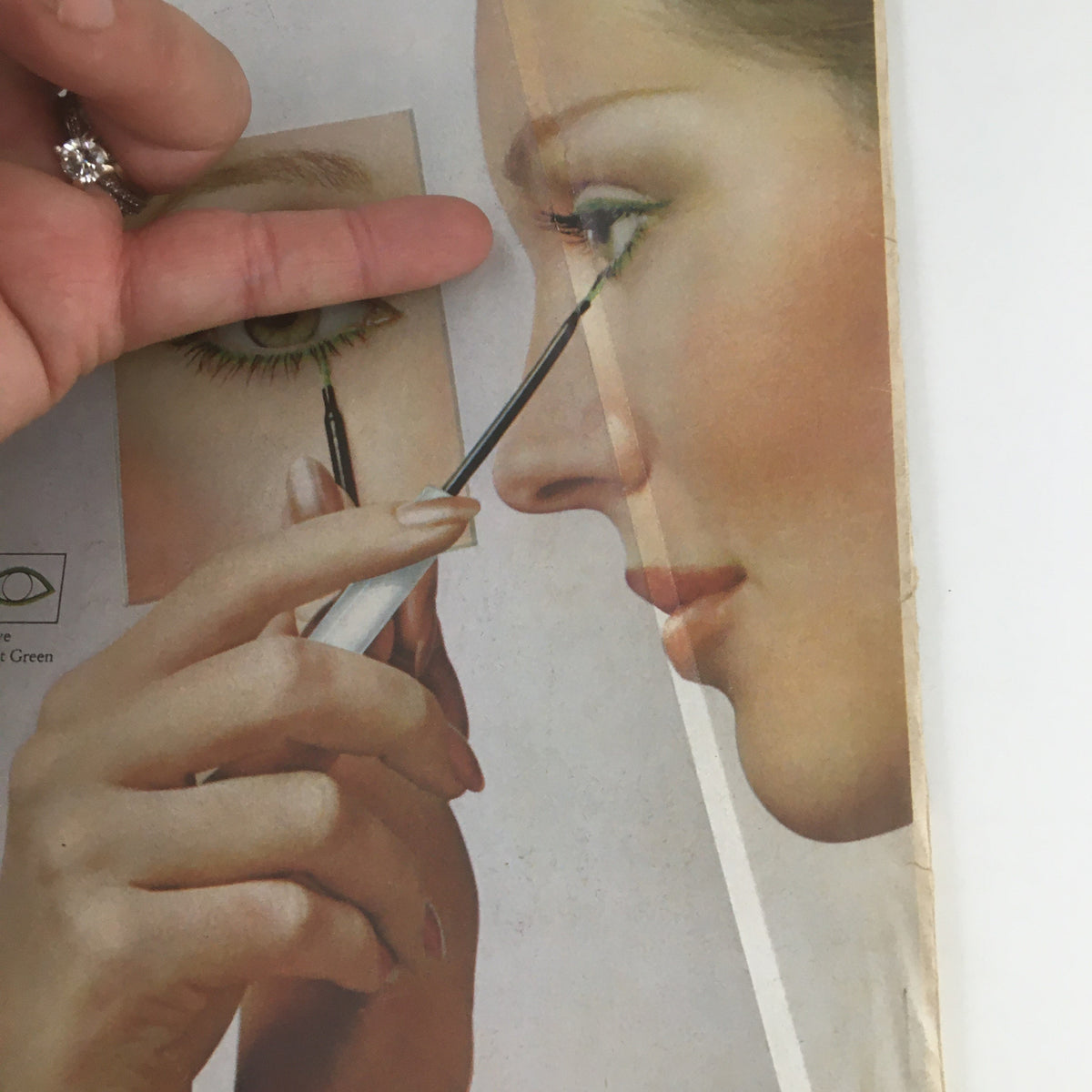 Illustration from Adam Film World Magazine August 1973 showing a woman applying green eye makeup, highlighting beauty trends and styles of the era.