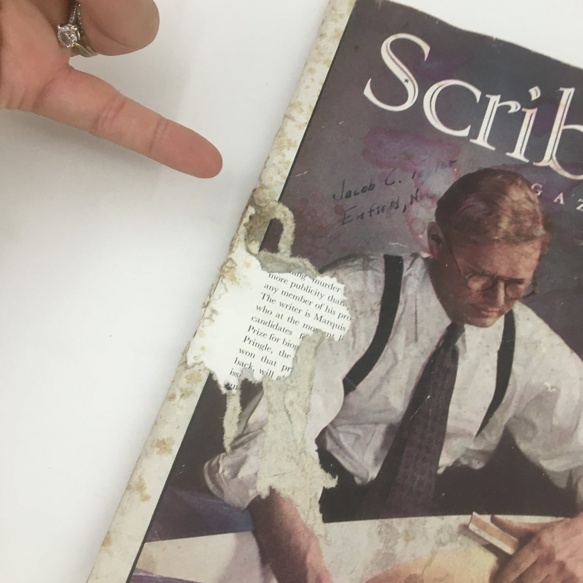 Cover detail of Scribner's Magazine June 1938, Volume 103, Number 6 featuring a man in glasses with a typewriter. Note the wear and marks indicating its historical journey.