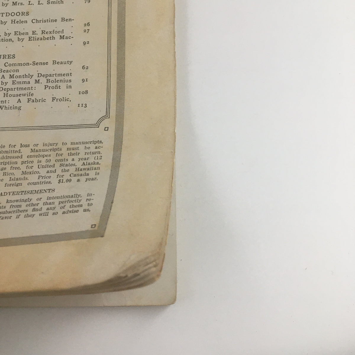 Close-up of a vintage McCall's Magazine March 1916 showcasing article 'Our Housekeeping Exchange', highlighting home management tips and advertisements.
